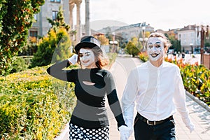 A couple of merry mimes. He hurries on a date