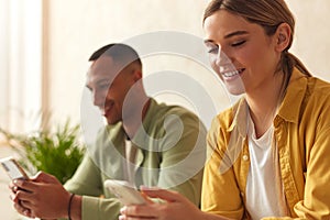 Couple Messaging Smartphones At Home. Married Couple Relaxing With Mobiles