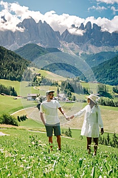 Couple mid age men and woman visiting the Italian Dolomites in Italy Alpe di Susi, Seiser alm