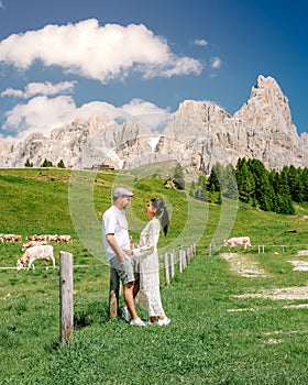Couple mid age men and woman visiting the Italian Dolomites in Italy Alpe di Susi, Seiser alm