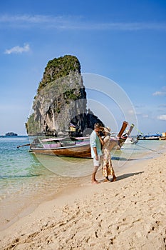 couple mid age on tropical beach in Thailand, tourist walking on a white tropical beach, Railay beach with on the