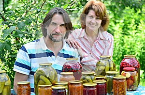 Couple of middle age with homemade preserves and jams