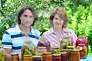 Couple of middle age with homemade preserves and jams