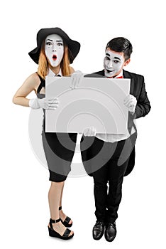 Couple of mimes holding placard