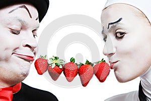 Couple of mimes with the strawberry on a white ba