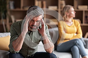 Couple Misunderstanding. Depressed Middle Aged Man Sitting Upset After Argue With Wife