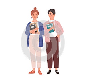 Couple of modern students with books in hands. Young man and woman holding textbooks. Portrait of teenagers standing