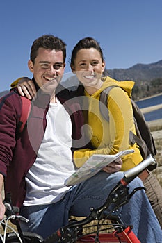 Couple With Mountain Bike And Roadmap