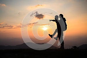 Couple on the mountain, Silhouette of happy couple  having fun over mountains background