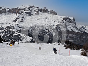 Couple of Mountaineers Climbing the Mountain with Snowshoes on their Feet and in the background the Italian Alps Mountains