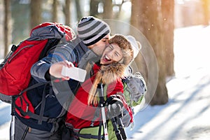 Couple of mountaineers taking selfie on winter