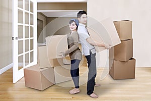 Couple moving boxes in new house