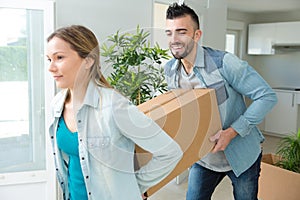 couple moving cardboard boxes