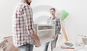 Couple moving furnishings in their new house