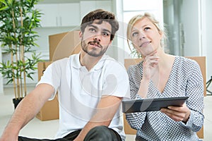 Couple moving home and buying on line with tablet