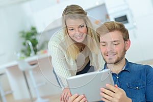 Couple moving home and buying on line with tablet