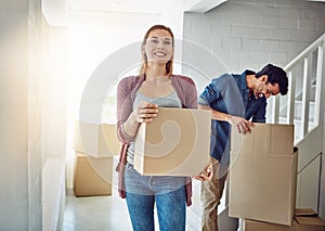 Couple, moving and new home with boxes, smile and happiness with real estate, lens flare and achievement. Apartment, man