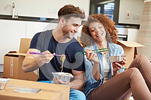 Couple Moving Into New Home Enjoying Takeaway Meal