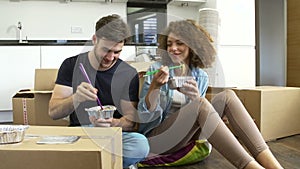 Couple Moving Into New Home Enjoying Takeaway Meal