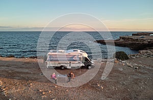 Couple near camper and view to the Mediterranean Sea