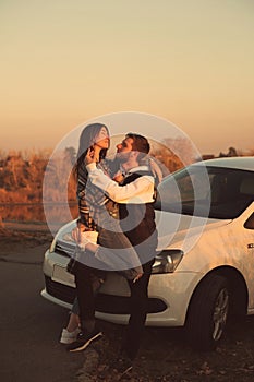 Couple near car sunset