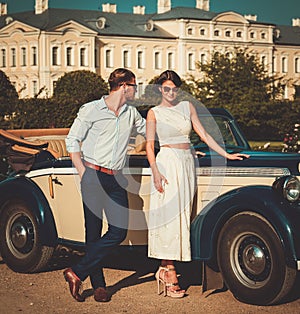 Couple near classic convertible