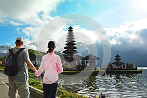 Couple near the famous temple Pura Ulun Danu at Beratan lake, Bali