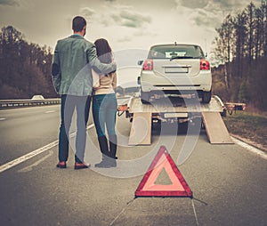 Couple near tow-truck