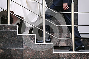 A couple of newlyweds going up the stairs