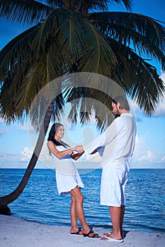 Couple nex to Palm tree