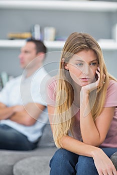 Couple not speaking after a fight on the sofa