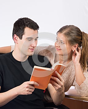 Couple in office reading a book
