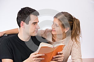 Couple in office reading a book