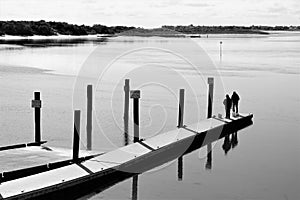 Couple of old guys fishing at end of boat ramp