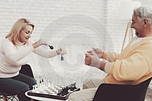 Couple of Old People Playing Chess at Home.