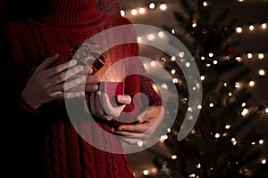 Couple open Christmas gift box with shiny lights on bokeh background