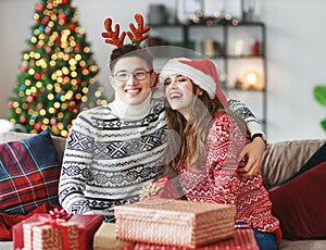 Couple opening presents on Christmas morning