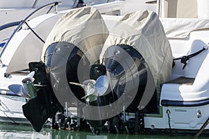 Couple of outboard engines with cover