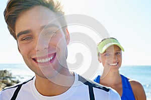 Couple, outdoor and portrait in beach, workout and fitness with smile, training and sunrise for run. Man, woman and