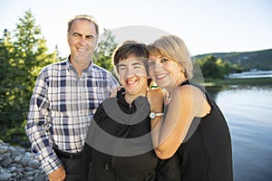 Couple outdoors with disabled person daughter by lake having good time