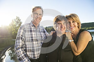 Couple outdoors with disabled person daughter by lake having good time