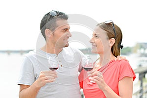 Couple outdoors drinking glass red wine