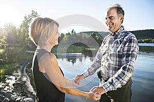 Couple outdoors by lake having good time