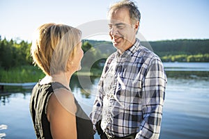 Couple outdoors by lake having good time