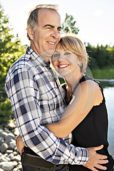 Couple outdoors by lake having good time