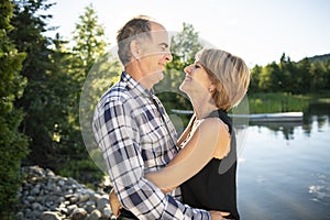 Couple outdoors by lake having good time