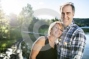 Couple outdoors by lake having good time