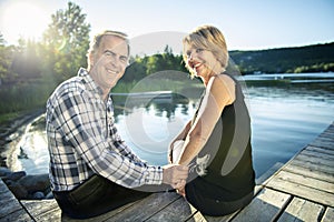 Couple outdoors by lake having good time