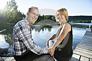 Couple outdoors by lake having good time