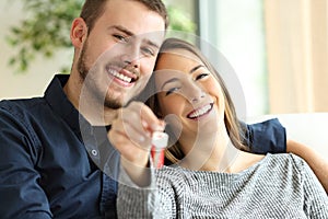 Couple of owners showing house keys